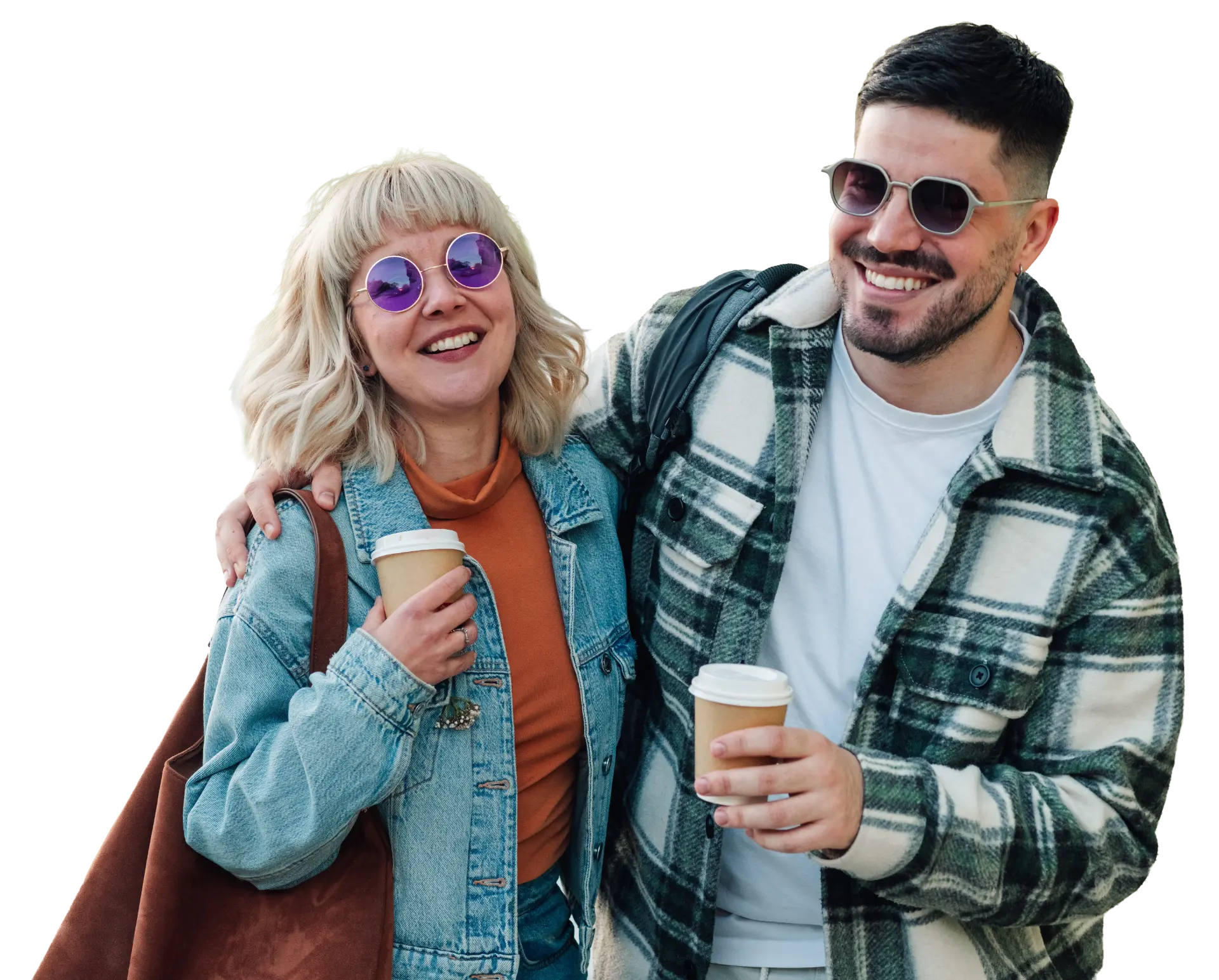 A smiling couple holding coffee cups